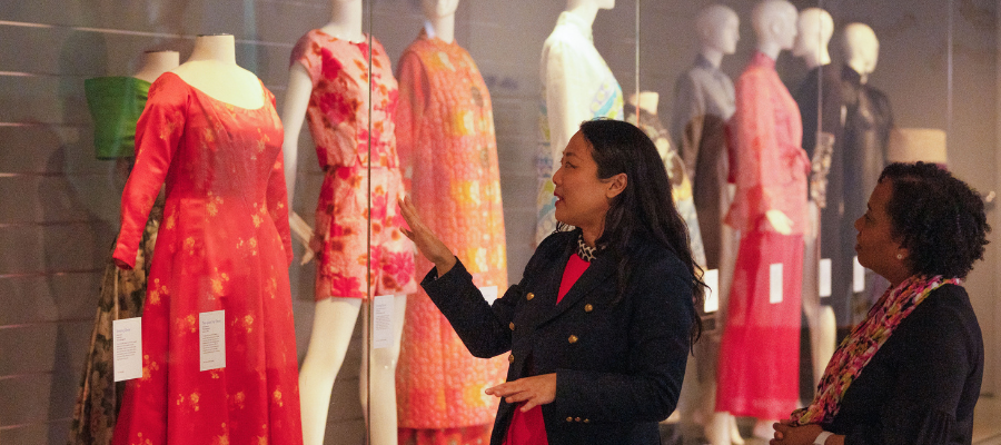 two women exploring a historic costume collection